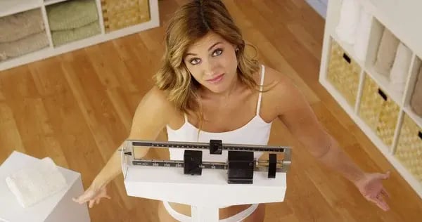 depositphotos_57329477-Frustrated-woman-unhappy-with-weight-gain